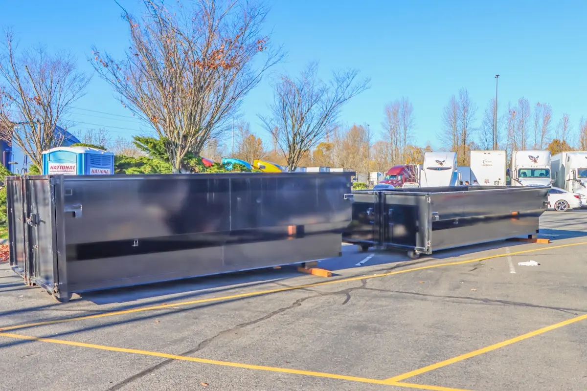 Professional dumpster rental service with roll-off container on residential driveway in Okeechobee